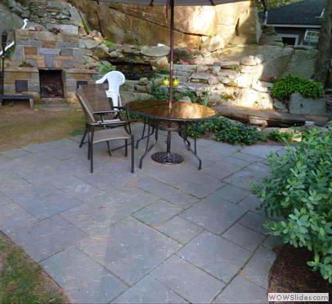 bluestone patie with fireplace and pond